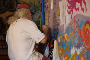 Visionary artist Brian Dowdall painting in a room 4C, winter 2016.